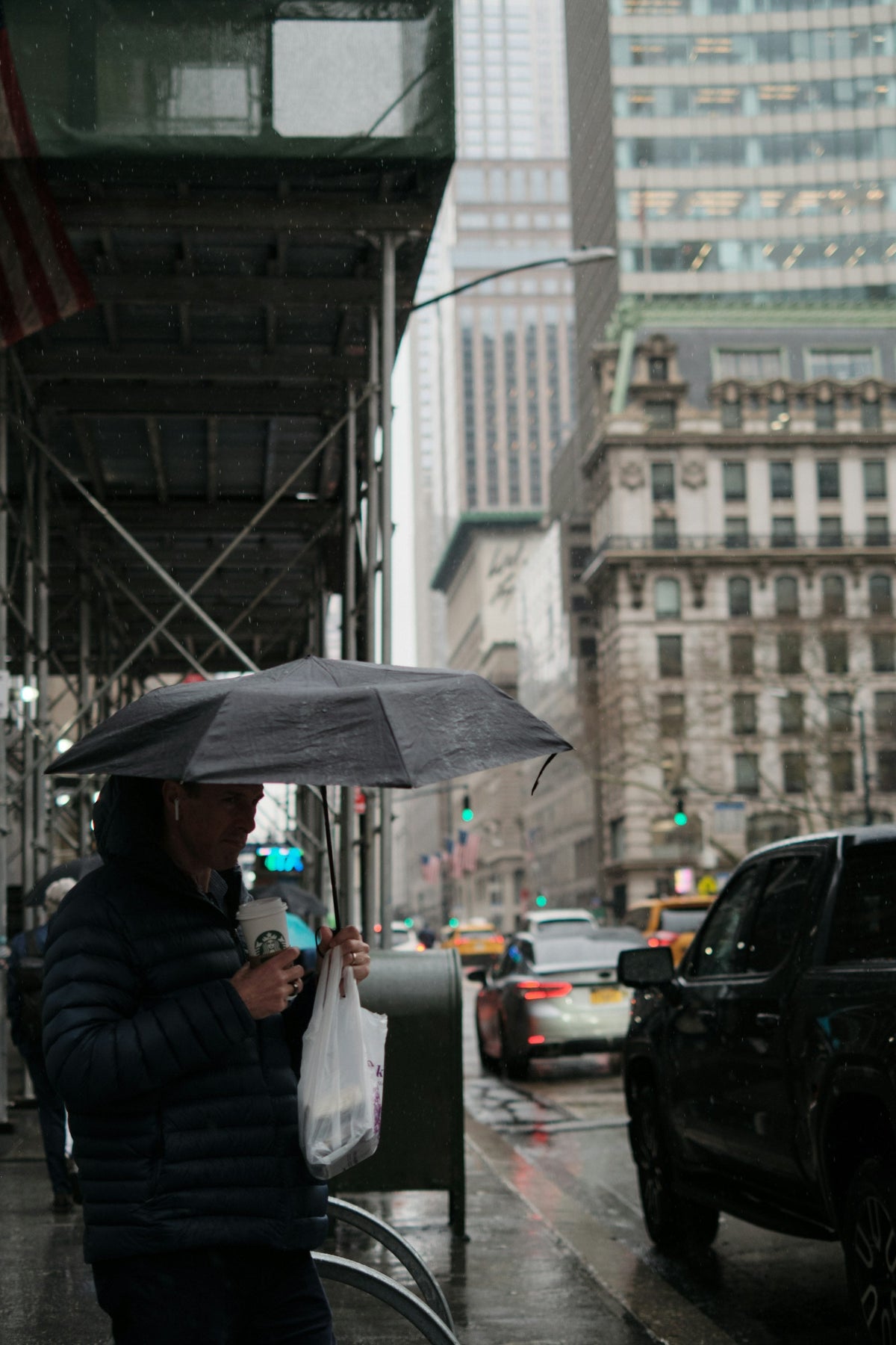 Traveler holding a compact folding umbrella on a city street