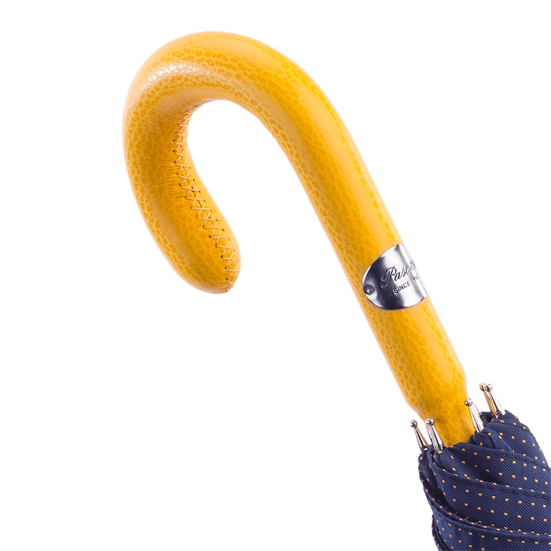 Men's navy umbrella with handmade Italian leather handle and yellow polka dots by Pasotti, featuring a classic design.