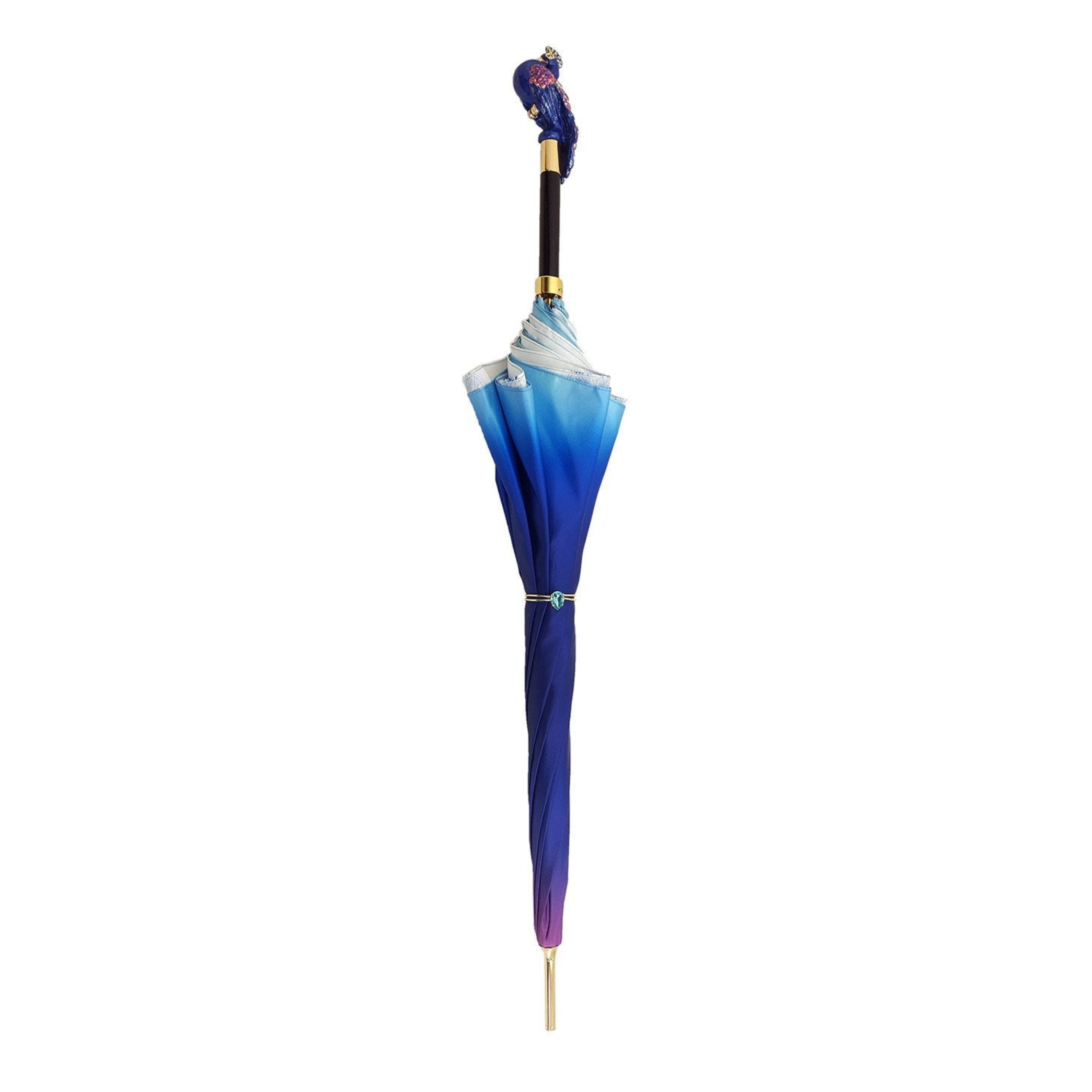 Blue peacock design luxury rain umbrella by Ilmarchesato with Swarovski crystal handle, featuring intricate feather pattern and elegant craftsmanship.