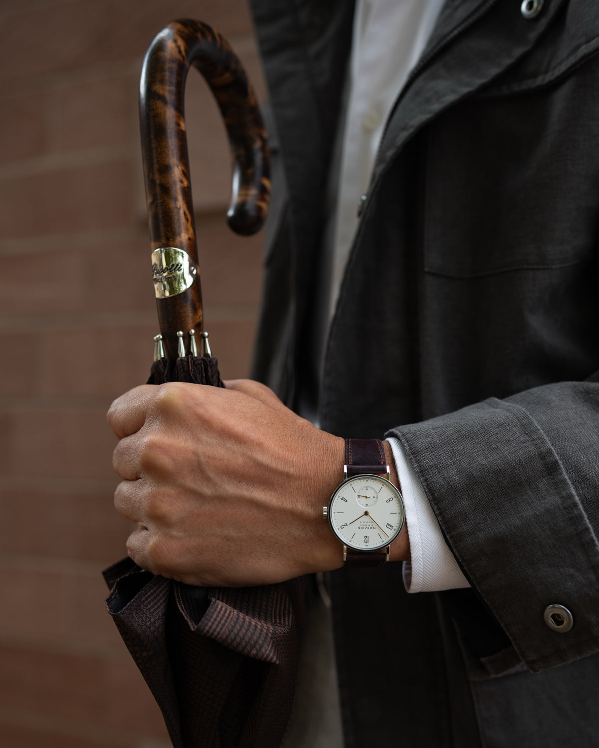 elegant designer umbrella with a handcrafted wooden handle and detailed canopy