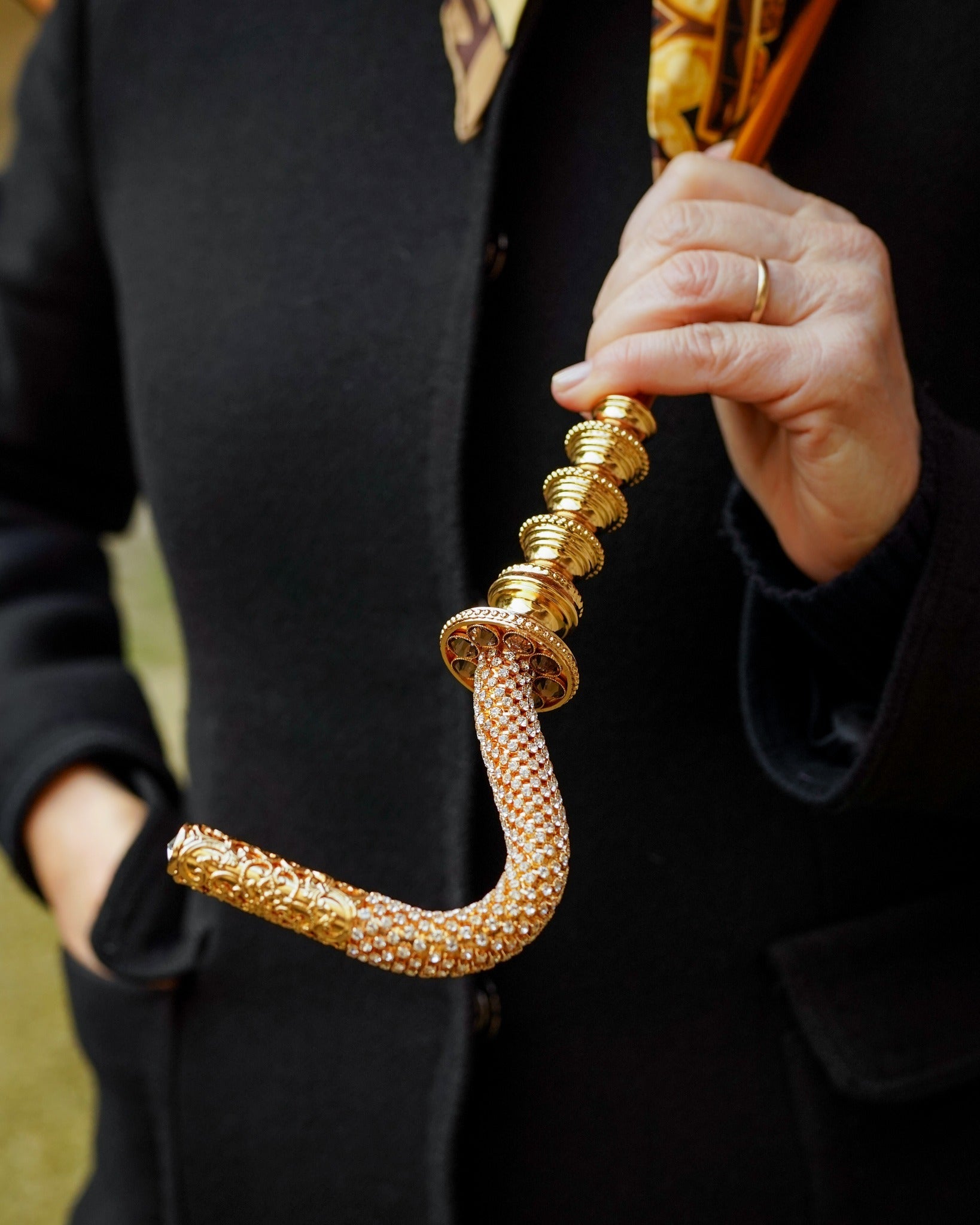 Handmade luxury women's rain umbrella by Ilmarchesato with a gold-plated handle and classic fancy design, open to showcase the canopy.