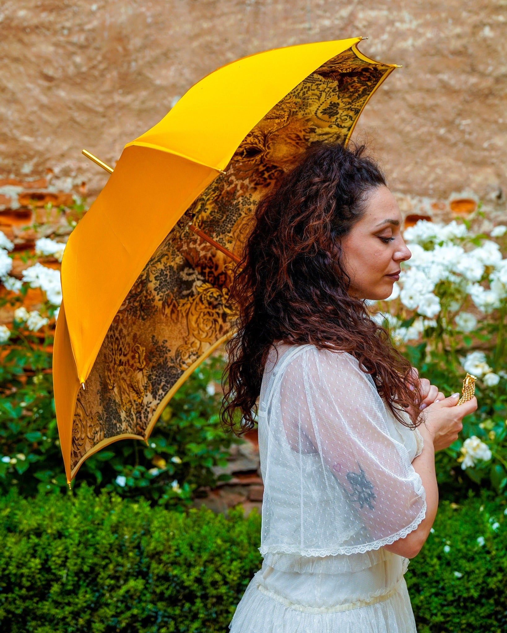 Golden satin rain umbrella by Ilmarchesato with Swarovski crystal details, double canopy, and 24K gold handle.
