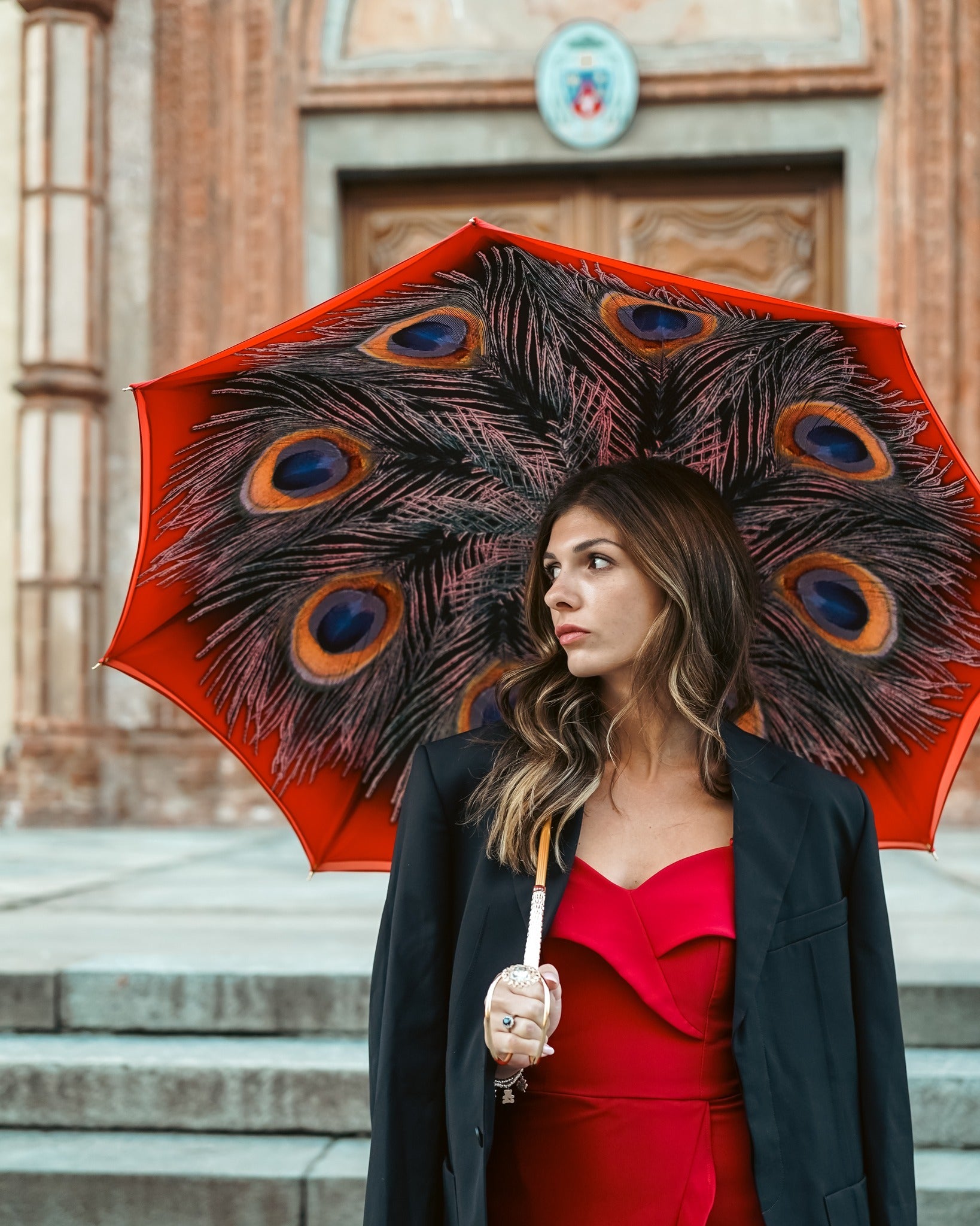 Red satin women's umbrella with peacock print, designer rain umbrella by Ilmarchesato, elegant and stylish for rainy days.
