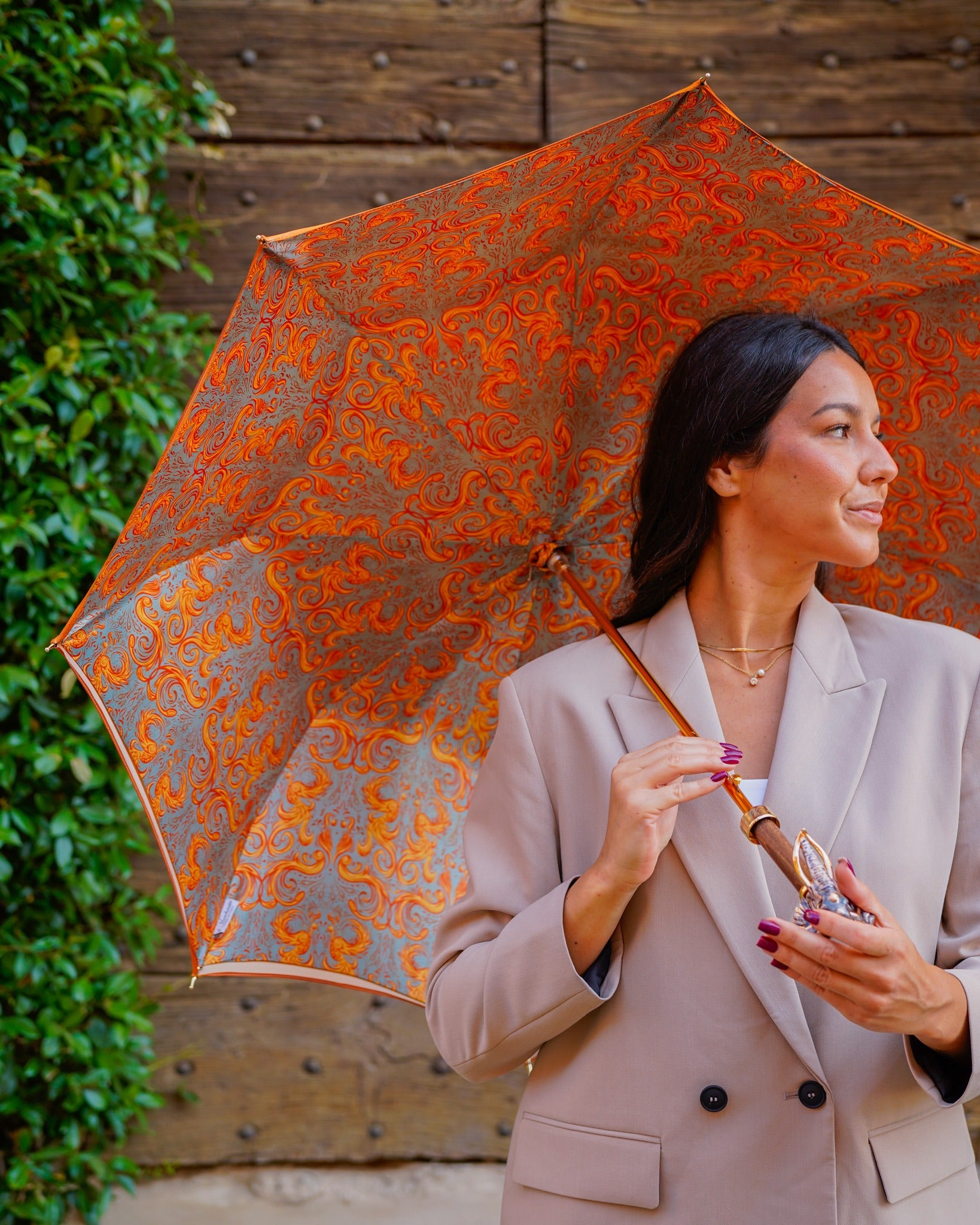 Golden elephant-shaped rain umbrella with satin canopy and 24K gold handle, luxury rain protection by Ilmarchesato.