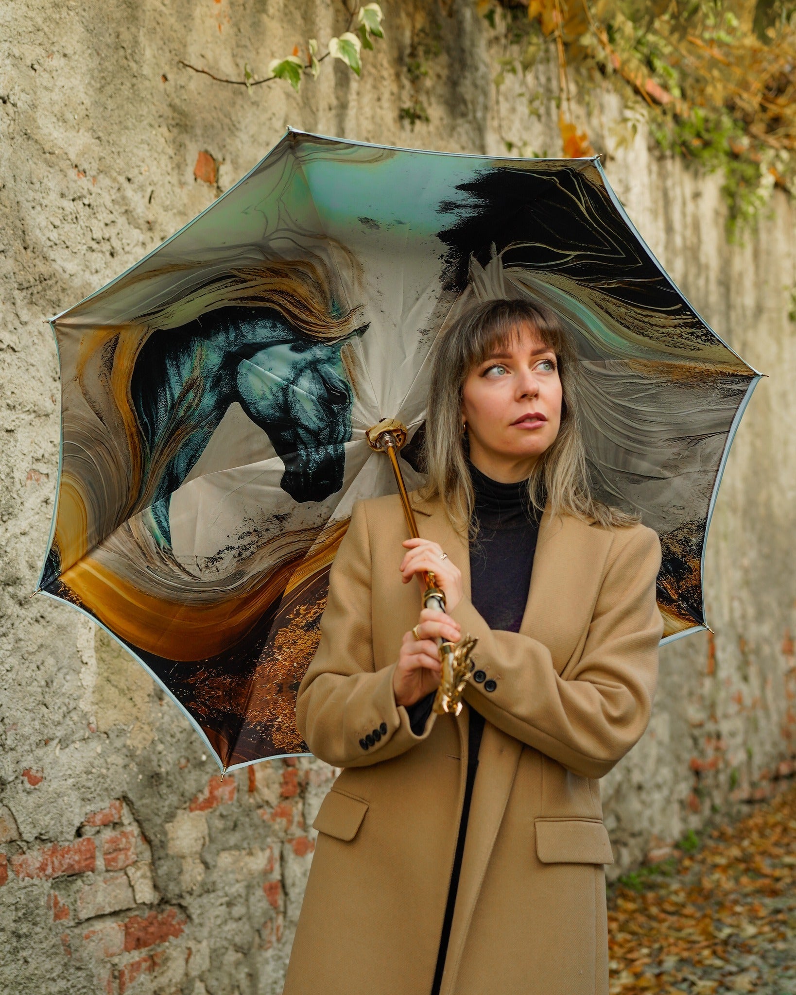 Light blue Ilmarchesato rain umbrella with gold horse handle and silk satin canopy, offering elegant rain protection.