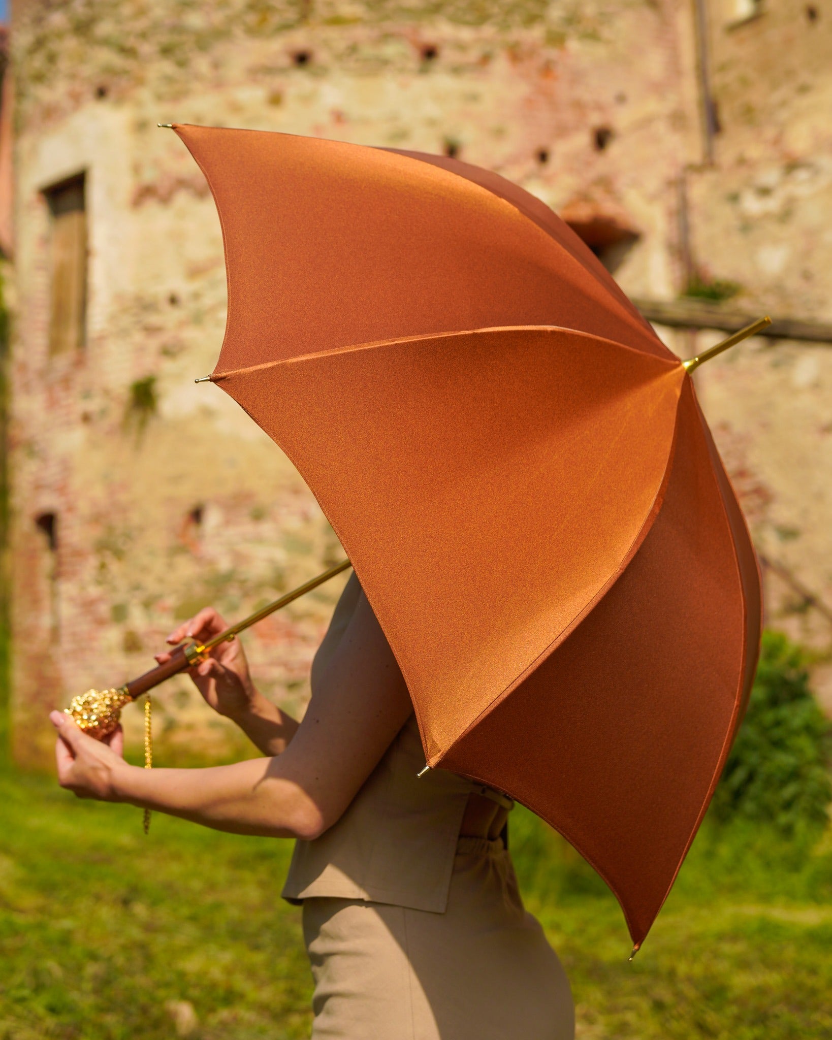 Luxury rain umbrella by Ilmarchesato with 24K gold-plated lion handle, satin canopy, and carbon fiber frame