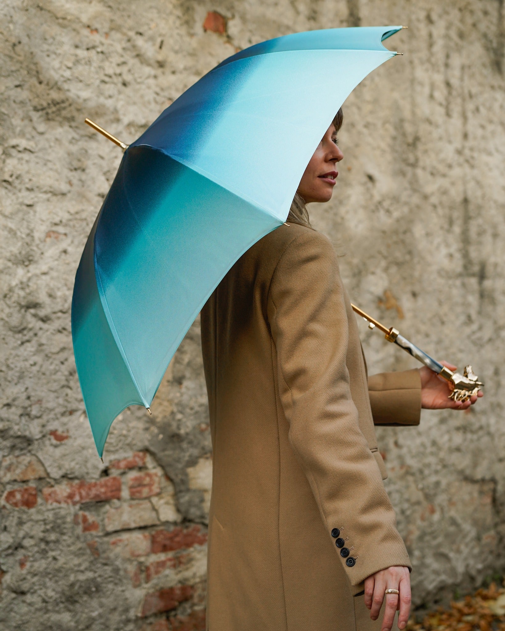 Light blue Ilmarchesato rain umbrella with a gold horse handle and silk satin canopy, providing elegant rain protection.