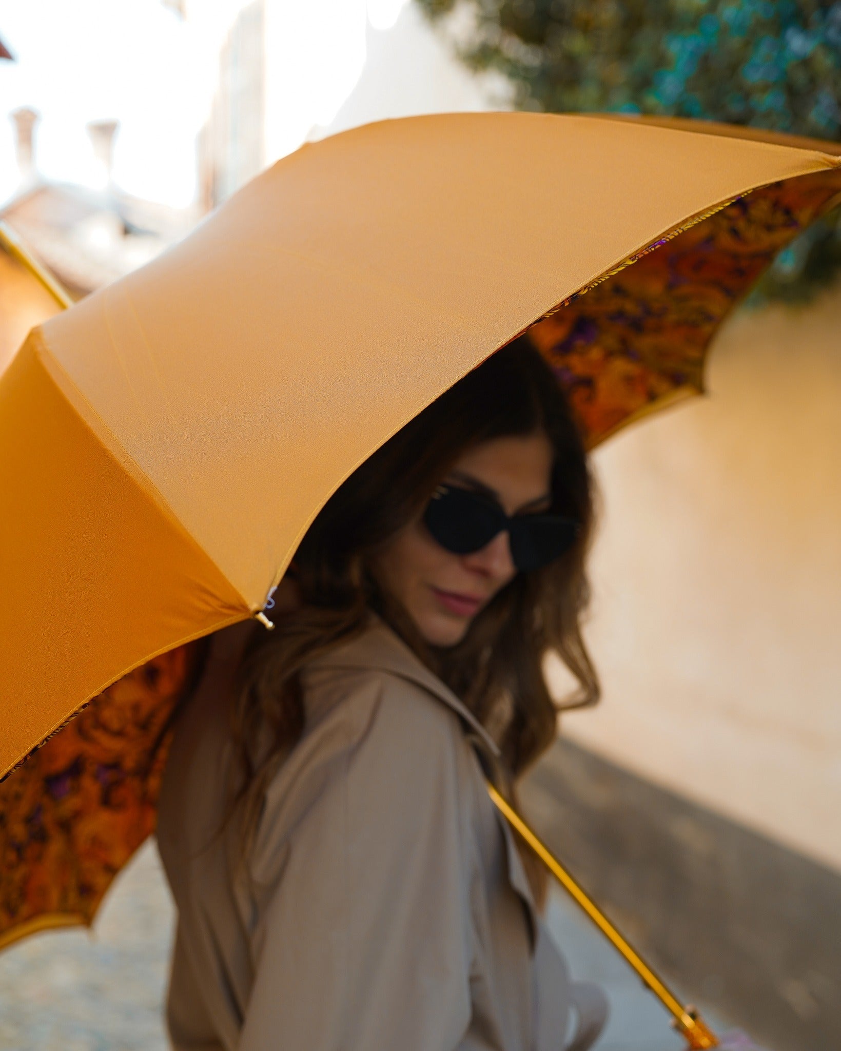 Orange leopard print rain umbrella with a handmade design and a 24K gold handle from Ilmarchesato.