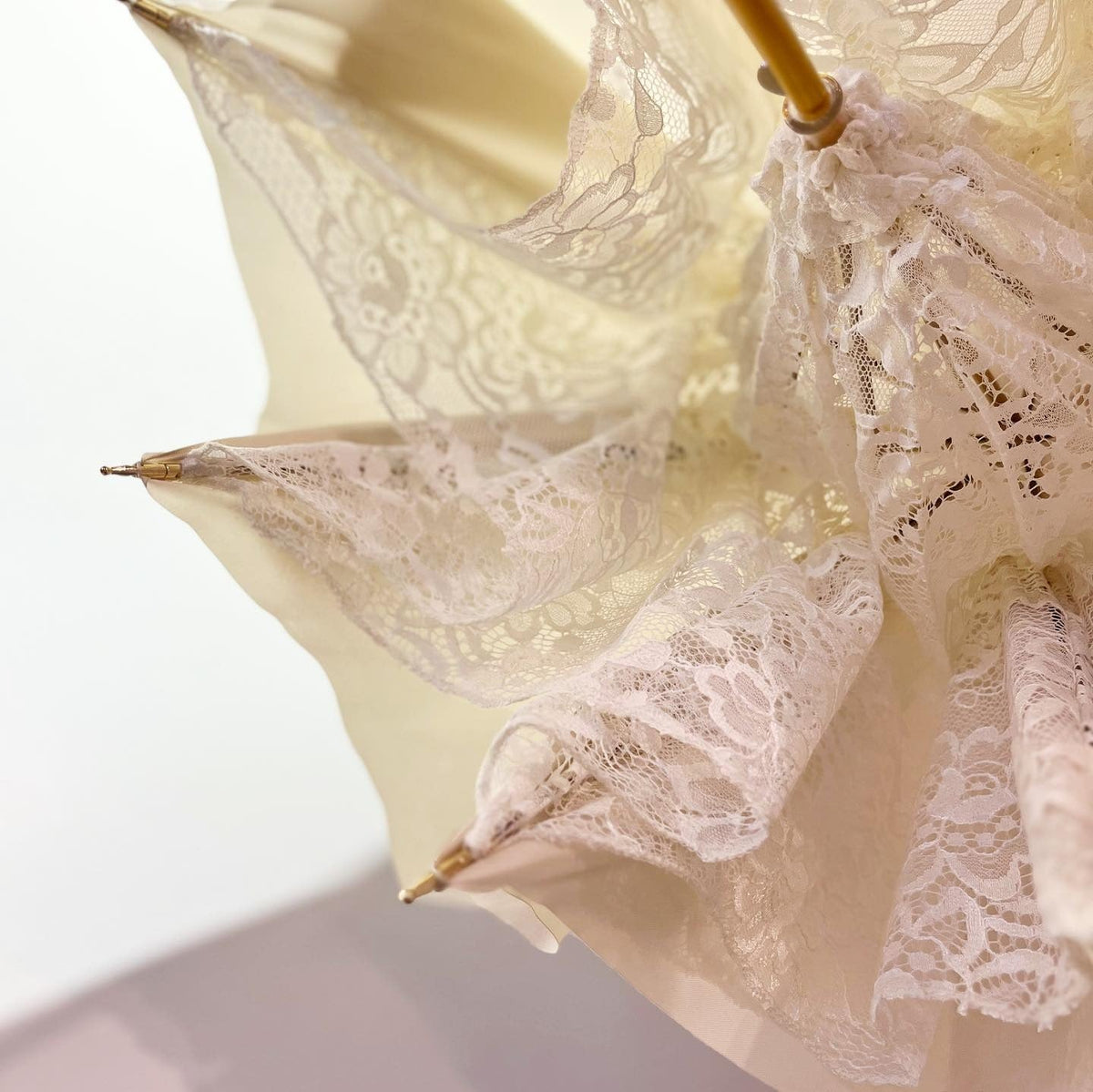 Detail of a white lace wedding umbrella canopy