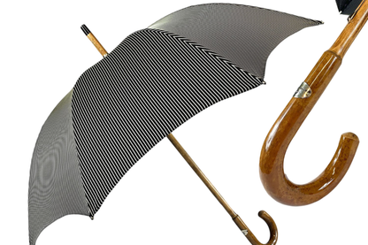 Black and white bespoke men's umbrella with hand-curved Malacca wood handle, featuring classic design and sturdy construction.