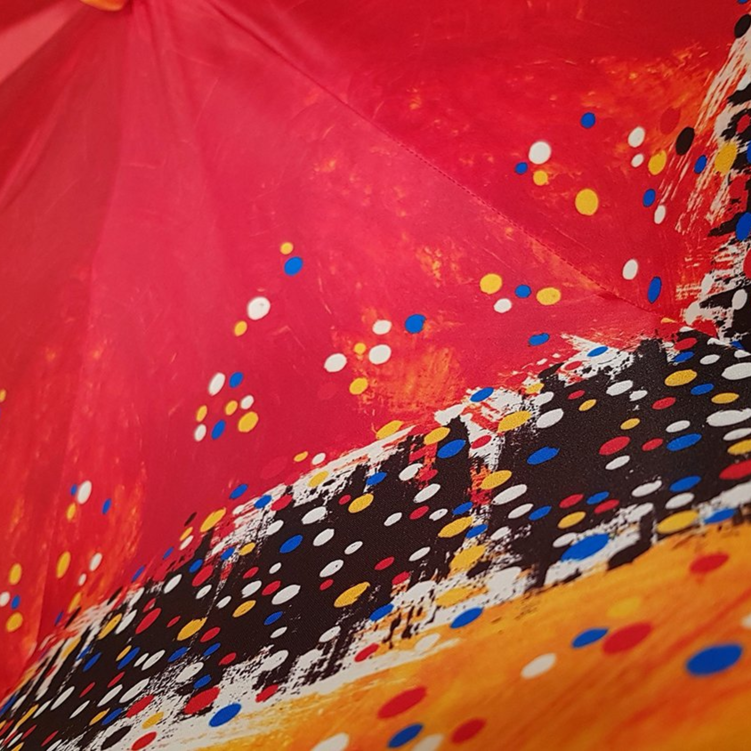 Ilmarchesato designer multicolored double canopy umbrella featuring a Swarovski handle against a neutral background.