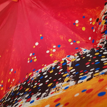 Ilmarchesato designer multicolored double canopy umbrella featuring a Swarovski handle against a neutral background.