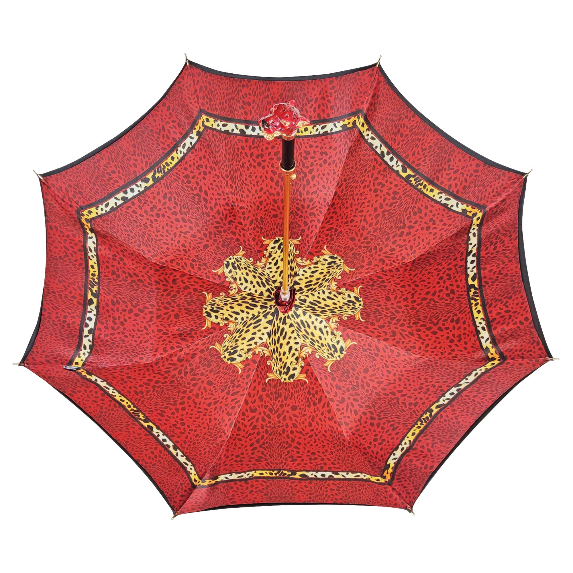 Red leopard print luxury umbrella by Ilmarchesato featuring a Swarovski crystal handle, open and displayed against a neutral background.