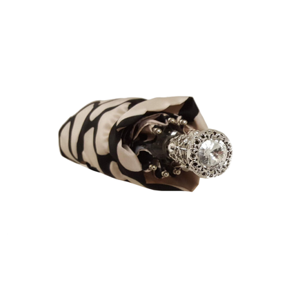 Ilmarchesato designer lightweight black and cream folding umbrella open, showcasing stylish pattern and compact design for women.