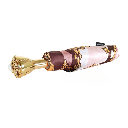 Chain print women's folding umbrella by Ilmarchesato with a 24K jeweled handle, featuring a stylish pattern and compact design.