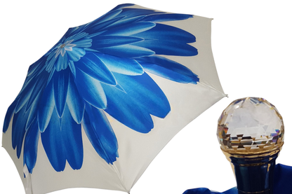 Blue Dahlia Ilmarchesato folding umbrella with 24K jeweled handle and vibrant floral design, compact and stylish for rainy weather.