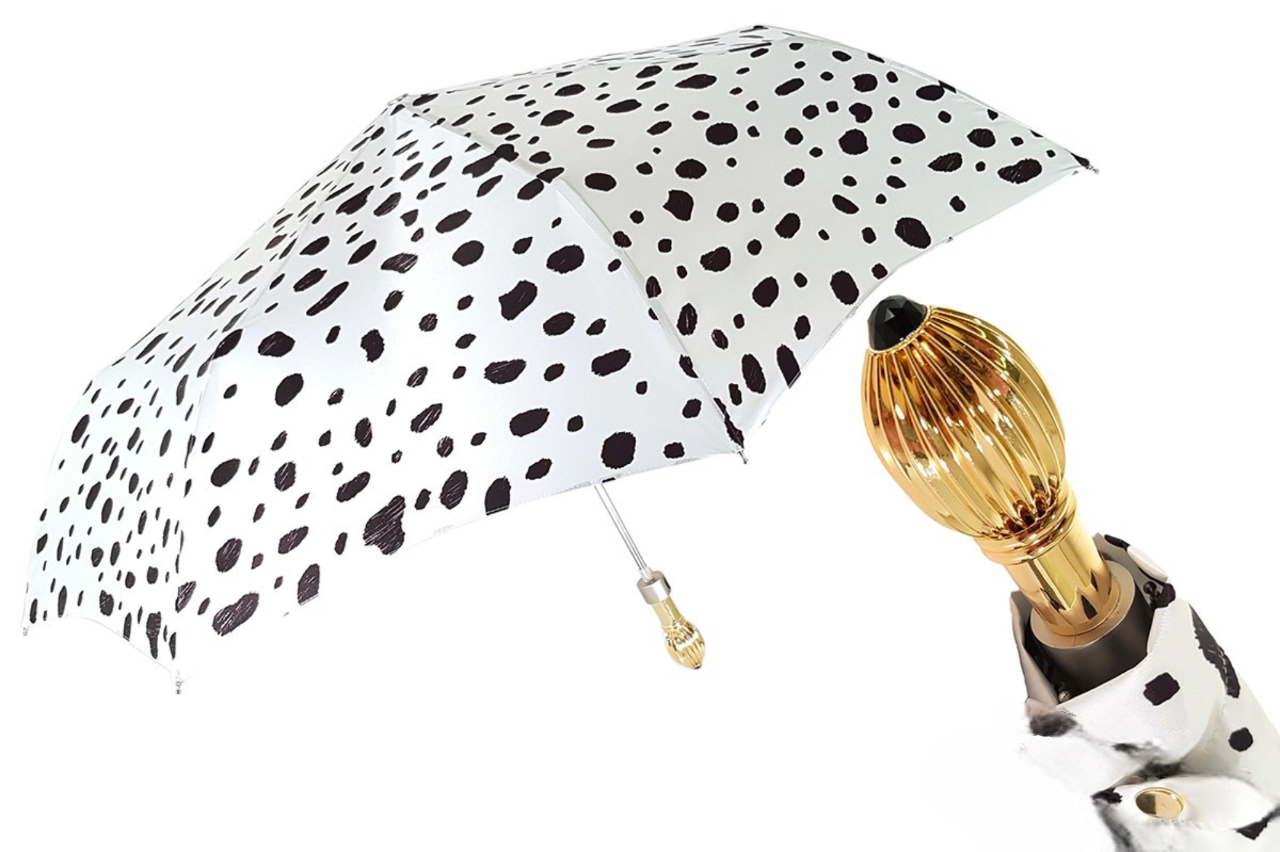 Black and white spotted Ilmarchesato folding umbrella with 24K jeweled handle, open showing its compact design and decorative details.
