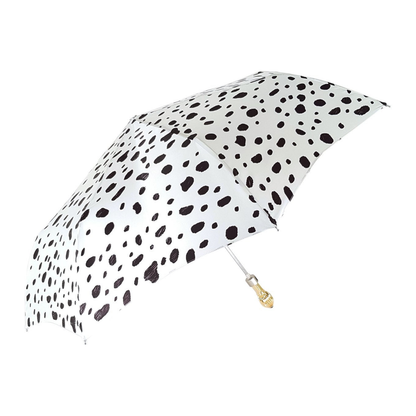 Black and white spotted Ilmarchesato folding umbrella with 24K jeweled handle, compact design, perfect for women’s rain protection.