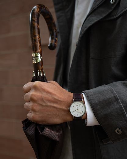 elegant designer umbrella with a handcrafted wooden handle and detailed canopy