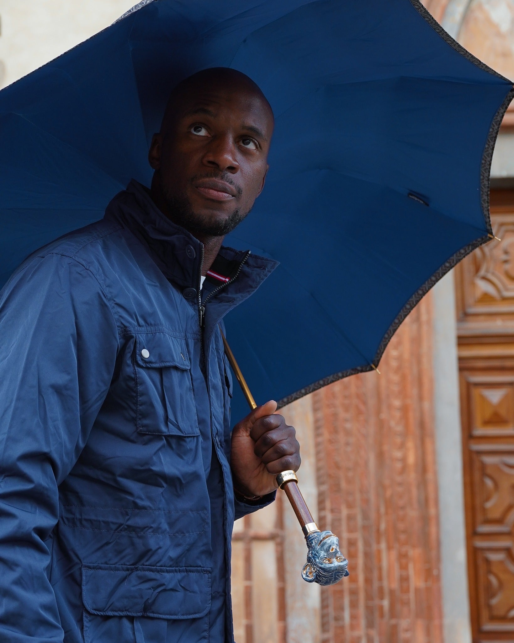 Italian handmade men's umbrella featuring a 24K gold-plated enameled monkey handle, crafted by Ilmarchesato.