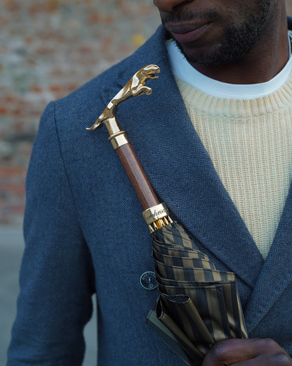 Black pinstripe men's umbrella by Ilmarchesato with 24K gold handle and automatic opening for luxury rain protection.