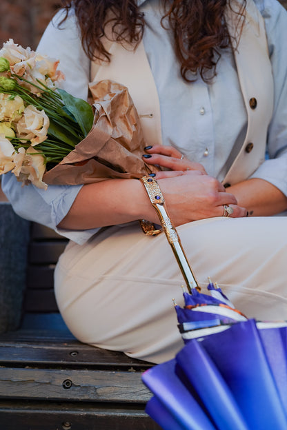 Luxury purple Ilmarchesato rain umbrella with double canopy and gold-plated handle, handmade Italian design, open to show its elegant canopy.