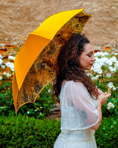 Golden satin rain umbrella by Ilmarchesato with Swarovski crystal details, double canopy, and 24K gold handle.