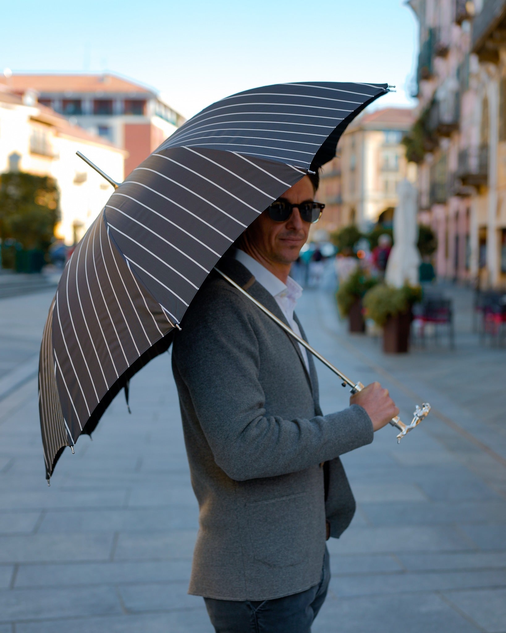 Black pinstripe men's rain umbrella with sculpted jaguar handle and automatic open, designed for stylish protection from the rain.