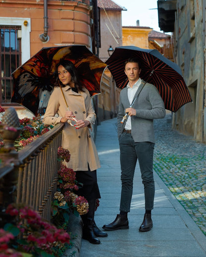 Colorful butterfly double canopy luxury rain umbrella for women by Ilmarchesato, open to show vibrant butterfly pattern and sturdy canopy.