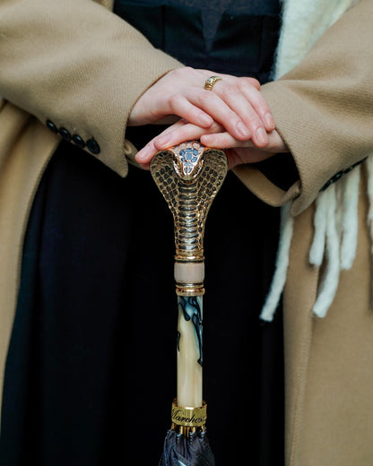 Golden cobra handle luxury rain umbrella for women by Ilmarchesato, featuring a designer handle and elegant design.