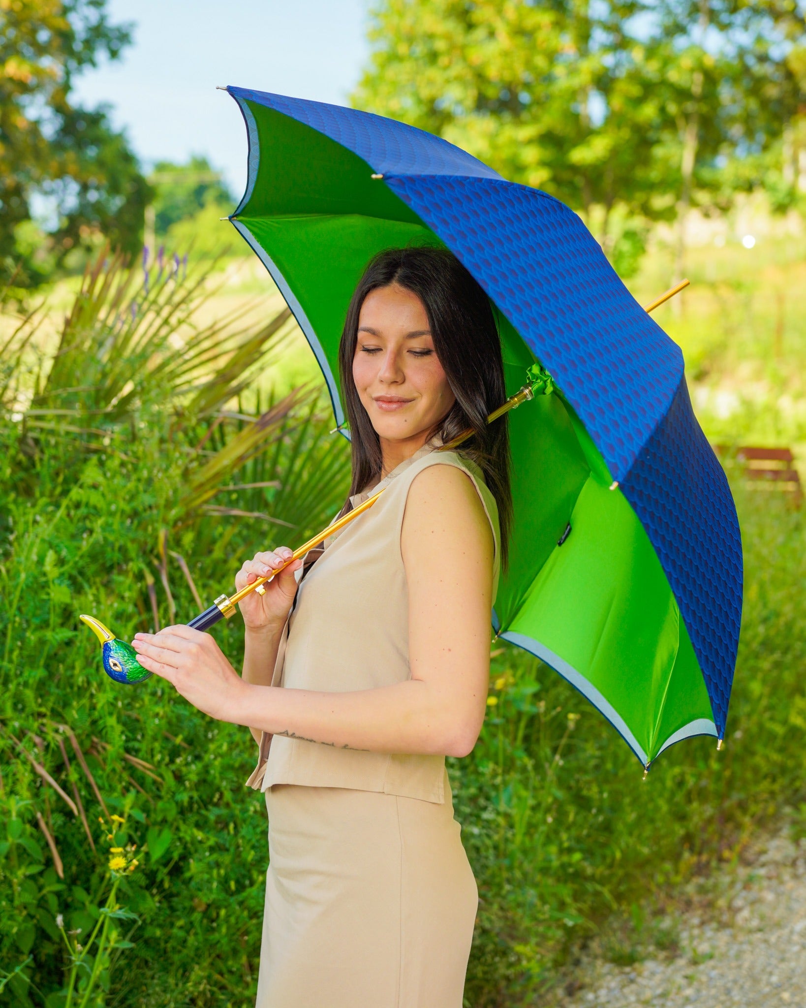 Hand-enameled duck umbrella by Ilmarchesato with satin canopy and 24K gold handle, luxury rain umbrella design.