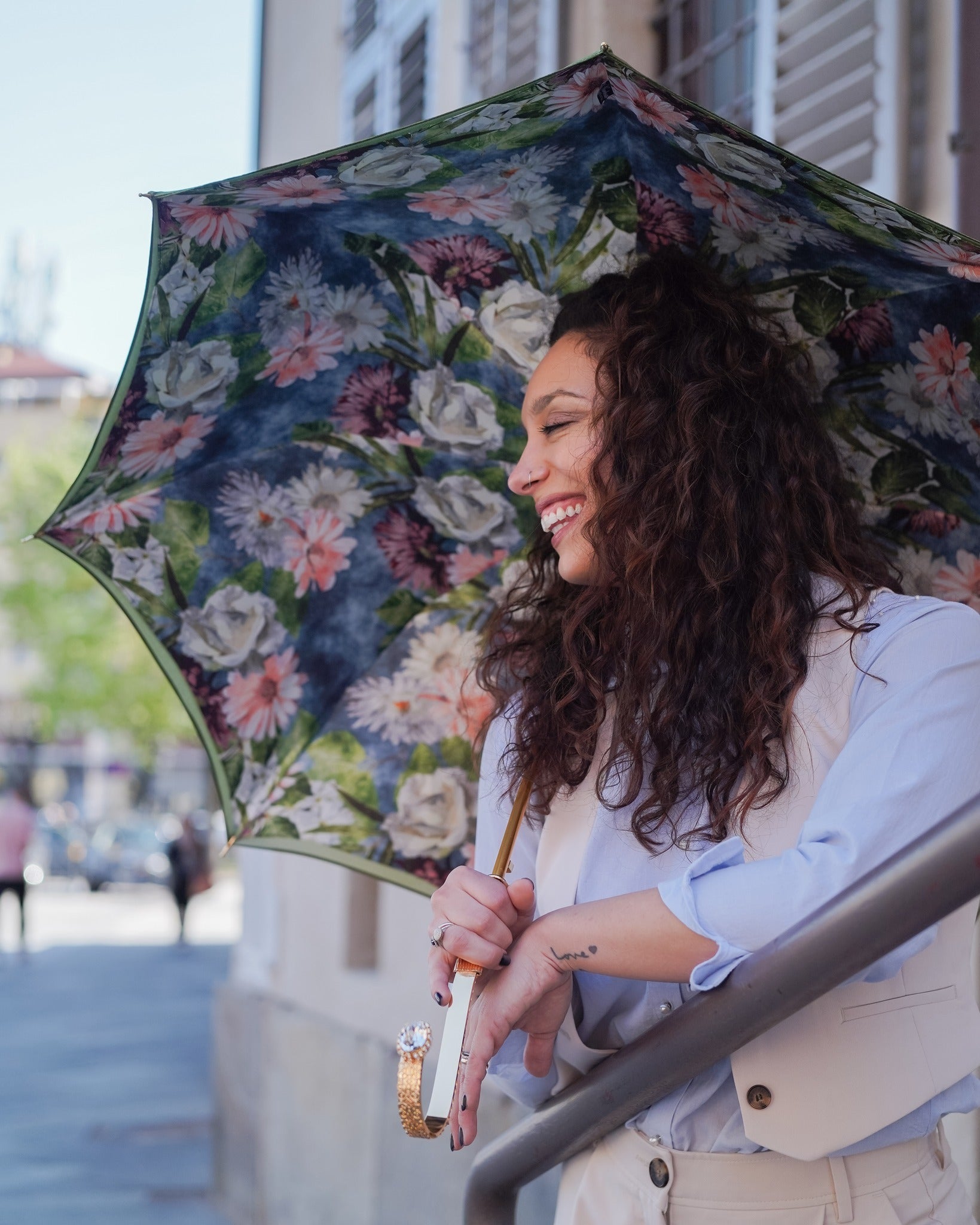 Elegant green floral double canopy rain umbrella by Ilmarchesato, showcasing its intricate floral pattern and sturdy design.