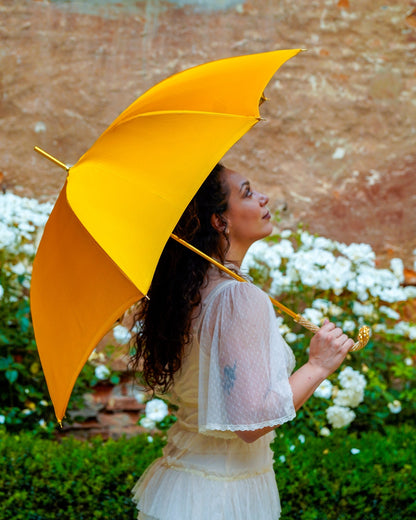 Golden satin rain umbrella by Ilmarchesato with Swarovski crystal details, double canopy, and 24K gold handle.