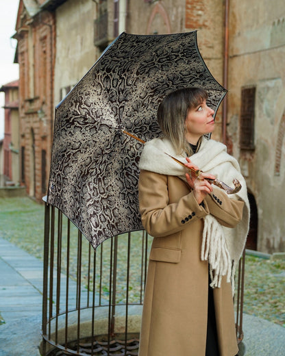 Golden cobra handle luxury rain umbrella for women by Ilmarchesato, featuring an elegant designer handle and vibrant canopy.