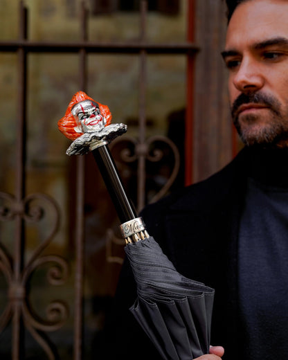 Grey men's umbrella with a hand-painted clown handle, showcasing Italian craftsmanship and detailed artistry.
