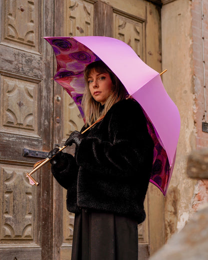 Luxury pink rain umbrella by Ilmarchesato with hand-painted floral handle, satin canopy, and wind-resistant design.