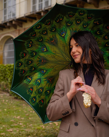 Green peacock umbrella by Ilmarchesato with a handmade Italian satin canopy, luxury rain gear for women, open to show intricate design.