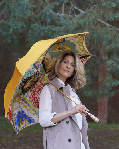 Luxury Italian rain umbrella by Ilmarchesato with satin canopy and hand-painted 24K gold handle, open to show elegant design.