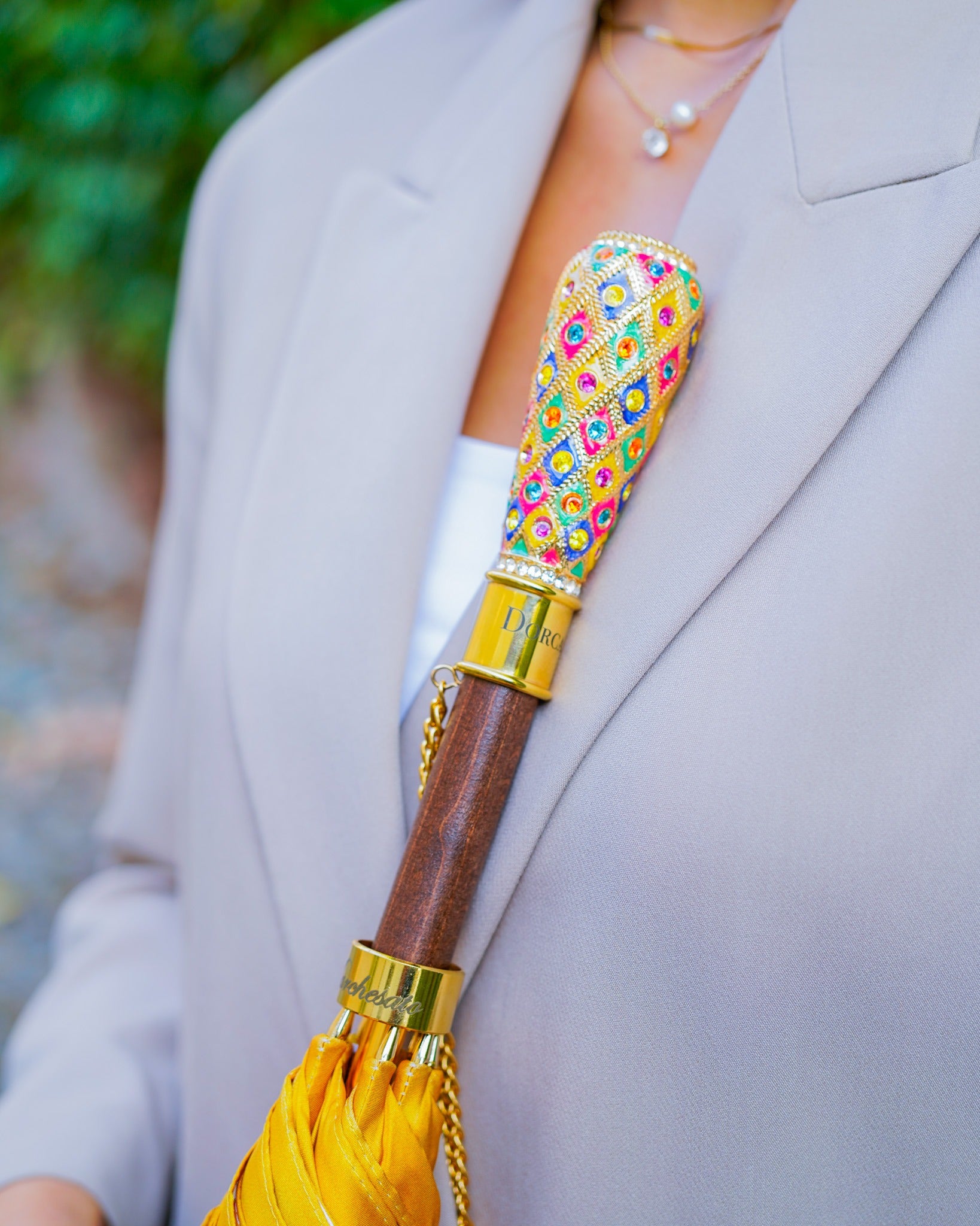 Luxury Italian rain umbrella with satin canopy and hand-painted 24K gold handle by Ilmarchesato, shown open with intricate details.