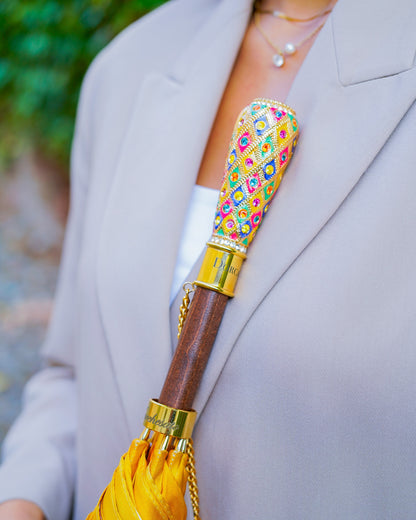 Luxury Italian rain umbrella with satin canopy and hand-painted 24K gold handle by Ilmarchesato, shown open with intricate details.