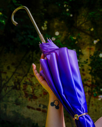 Vibrant pink and blue double canopy rain umbrella by Ilmarchesato with an artistic interior design.