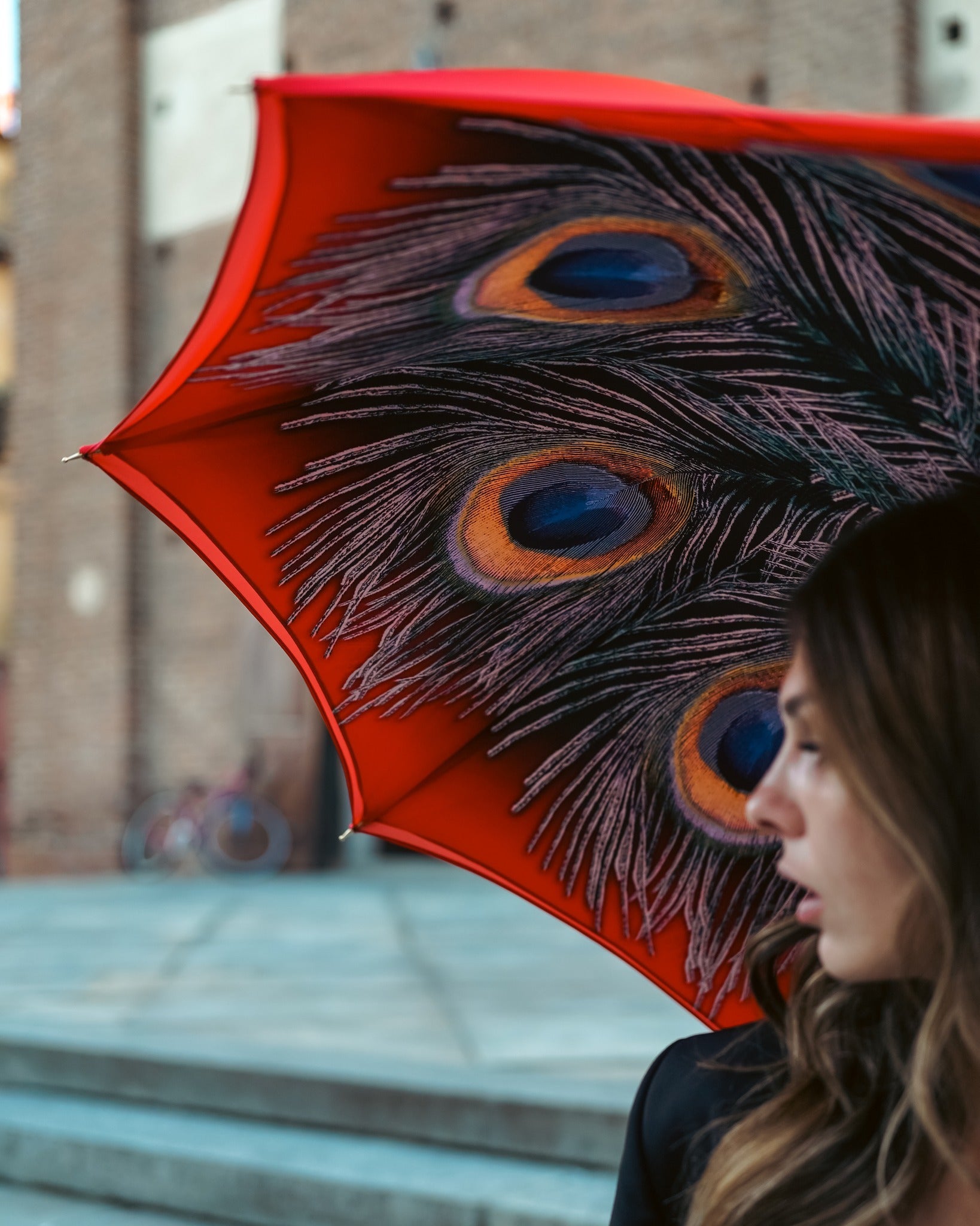 Elegant red satin women's rain umbrella with peacock print, featuring a designer style by Ilmarchesato.