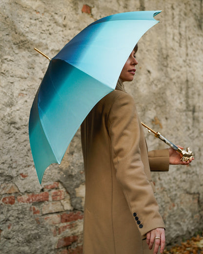 Light blue Ilmarchesato rain umbrella with a gold horse handle and silk satin canopy, providing elegant rain protection.