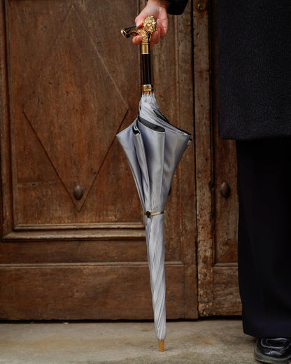 Luxury lion-handle rain umbrella by Ilmarchesato with a 24K gold satin canopy, stylish limited edition rain gear.