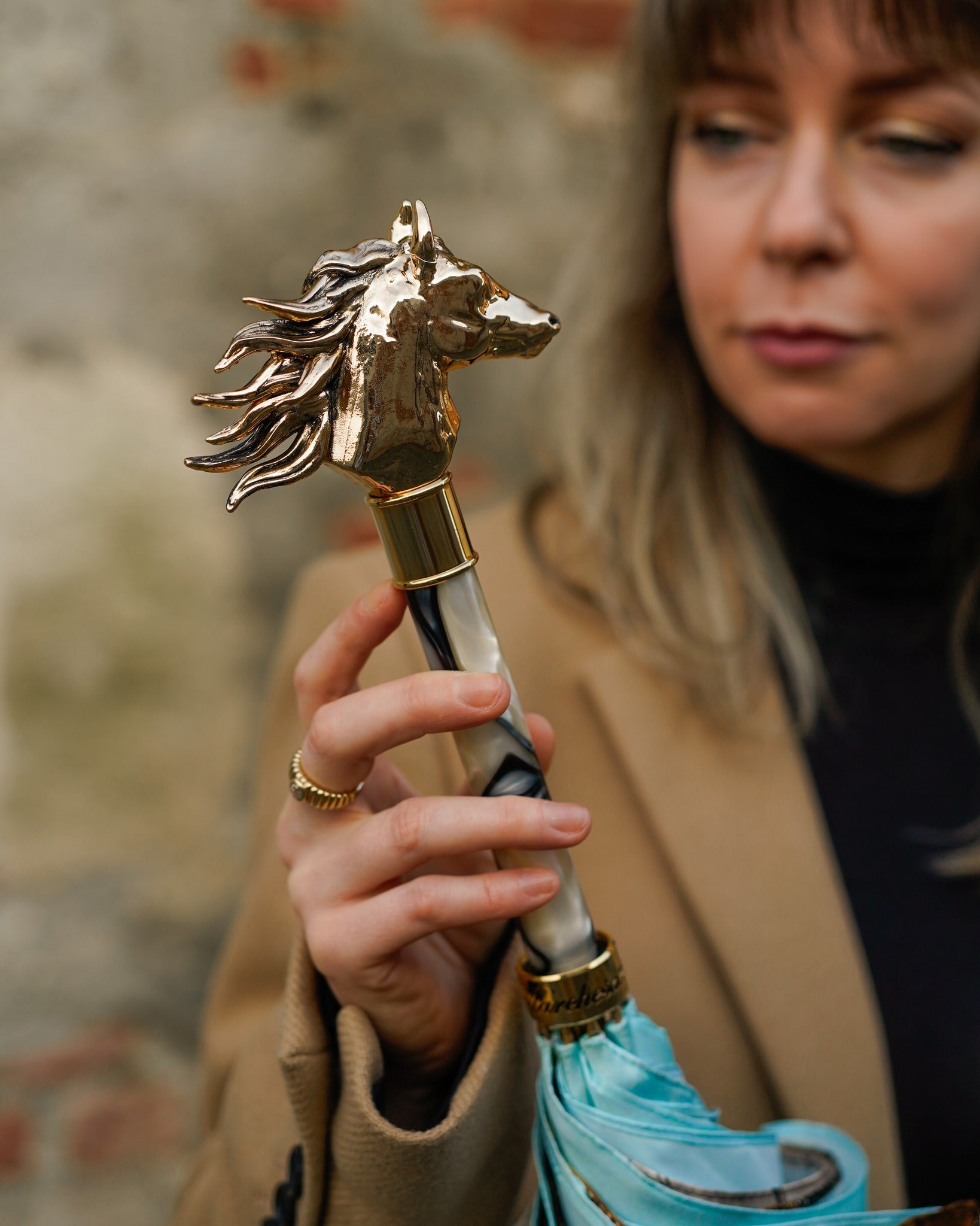 Light blue Ilmarchesato rain umbrella with gold horse handle and silk satin canopy, elegant rain protection accessory