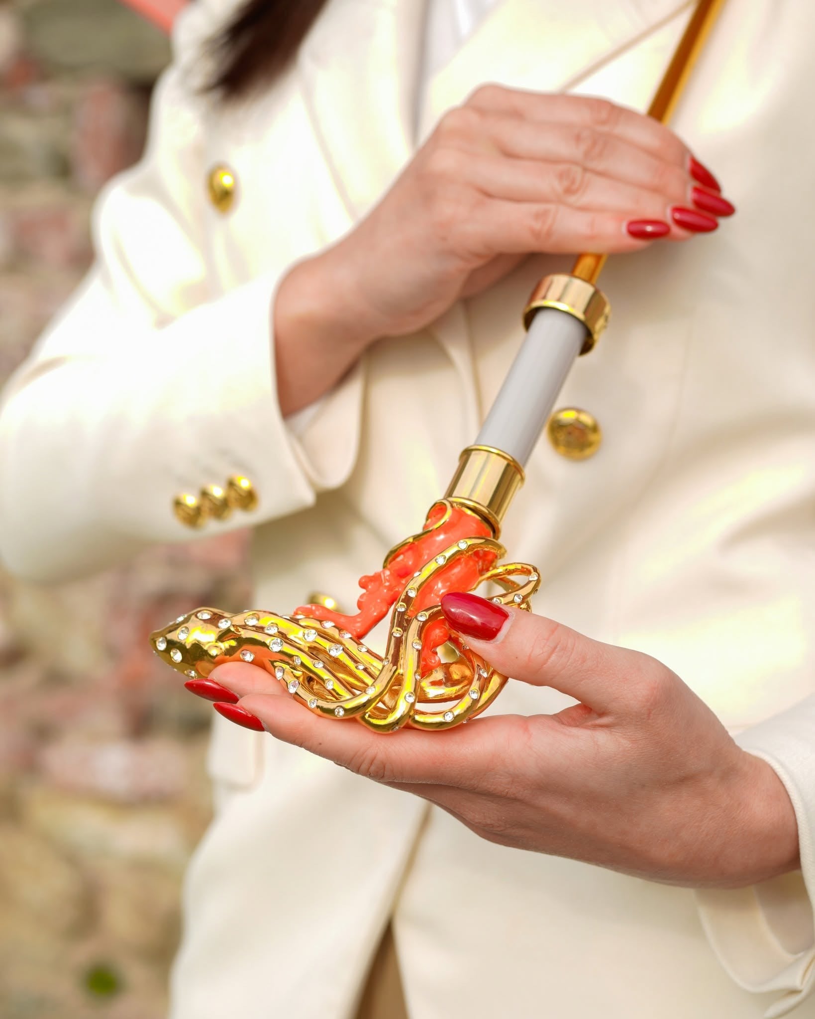 Handmade Italian goldplated octopus umbrella with Swarovski crystals, satin coral canopy, and intricate design for luxury rain protection.