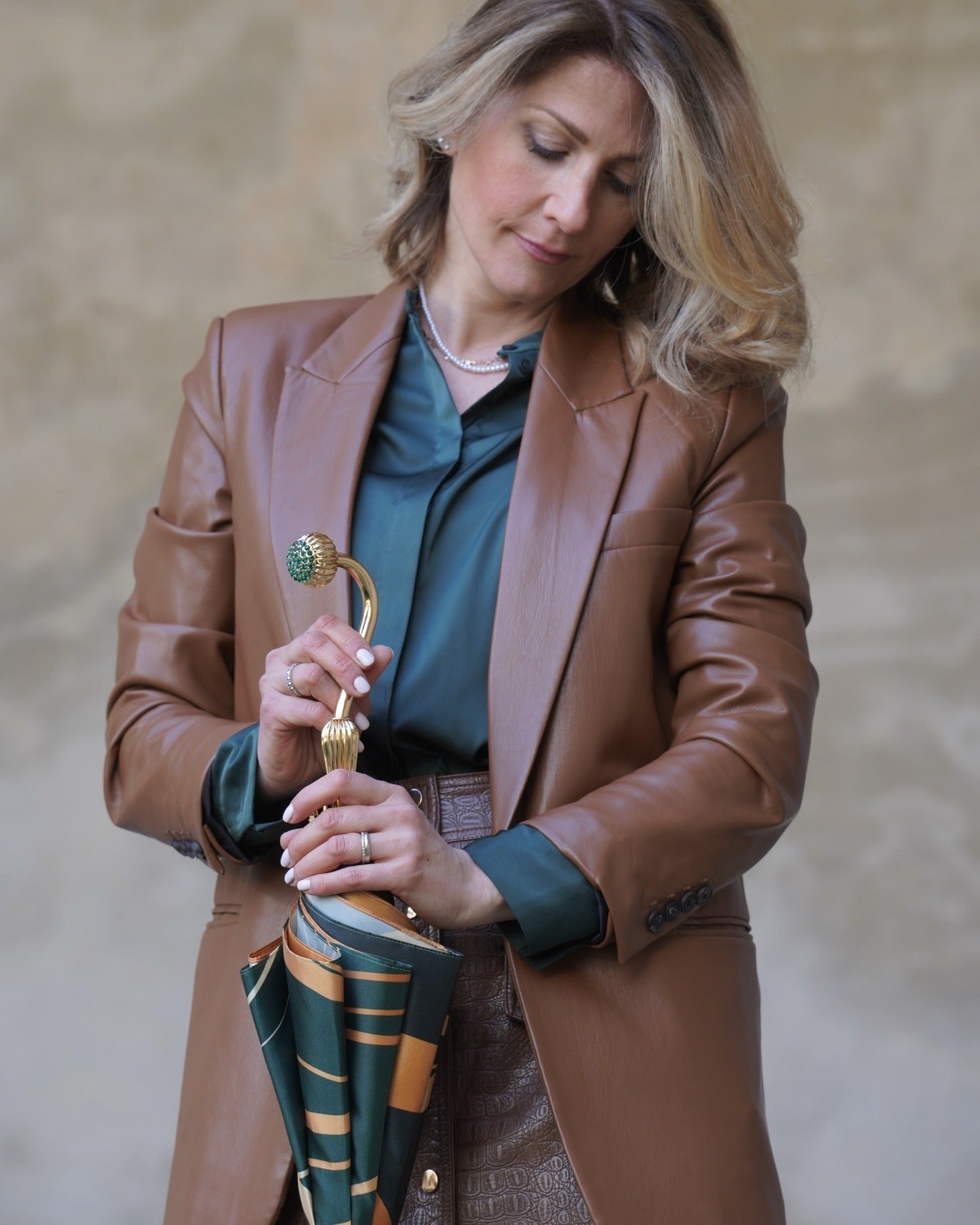 Gold plated rain umbrella with handmade Italian satin canopy and emerald crystal handle, stylish and elegant accessory.