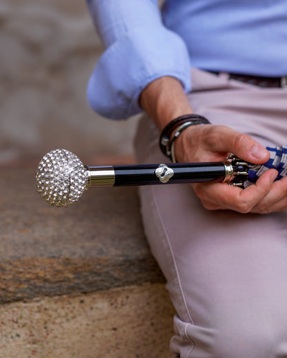 Luxury striped men's umbrella by Ilmarchesato with silverplated handle and crystal accents, showcasing its elegant design and vibrant stripes.