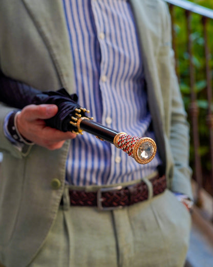 Black Greca men's umbrella by Ilmarchesato with gold handle and crystal set, showcasing a luxurious rain umbrella design.