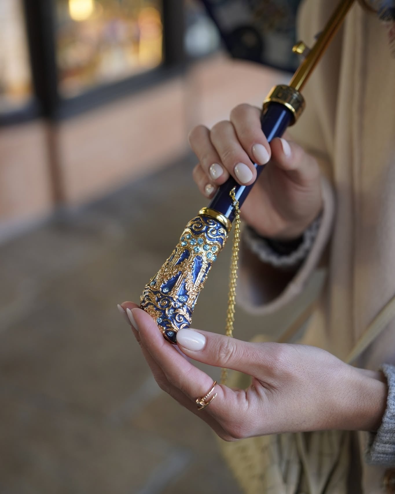 Luxury blue rain umbrella by Ilmarchesato with handmade Italian satin canopy and turquoise crystal handle, open to show design details.